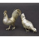 Pair of novelty Dutch silver pepper pots, modelled as a cock and hen each with detachable heads,