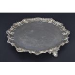 Victorian circular silver salver, with engraved decoration within a cast scroll and scallop rim