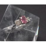 18ct white gold pink sapphire and diamond three stone ring, the oval sapphire estimated 1.10ct