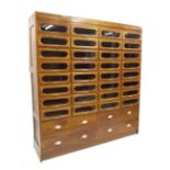 Early 20th century haberdashery cabinet with thirty-two sliding glazed doors over four deep drawers,