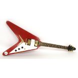 Flying V electric guitar inscribed Voodoo Soul to the head, red relic finish, fitted with a pair