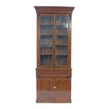 Tall 19th century mahogany secretaire bookcase, the moulded cornice over two long glazed doors