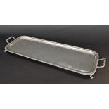 Silver oblong twin-handled tray, with a gadrooned border upon claw feet, with presentation silver
