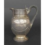 Late Victorian silver lidded water jug, of ovoid form with half fluted decoration and engraved