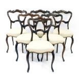 Set of six Victorian rosewood salon chairs, with balloon shaped backs and stuffover seats on