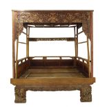 Impressive large Chinese opium bed, with elaborate gilt carving and red lacquer panelled detail, 7.