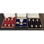 Two cased sets of six silver coffee bean spoons, dated 1924 and 1973 (Mappin & Webb); also a cased