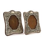 Matched pair of Art Nouveau silver photograph frames, each repousse with foliate scrolls and