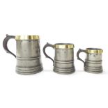 Graduated set of three brass rimmed straight-sided pewter measures, circa 1860, marked 'Browning and
