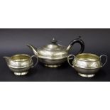 Matched three piece bachelor silver tea service, of squat ovoid form with a central reeded girdle,