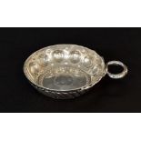 Silver wine tasting cup, with repousse reeded and roundel decoration with a dolphin entwined handle,