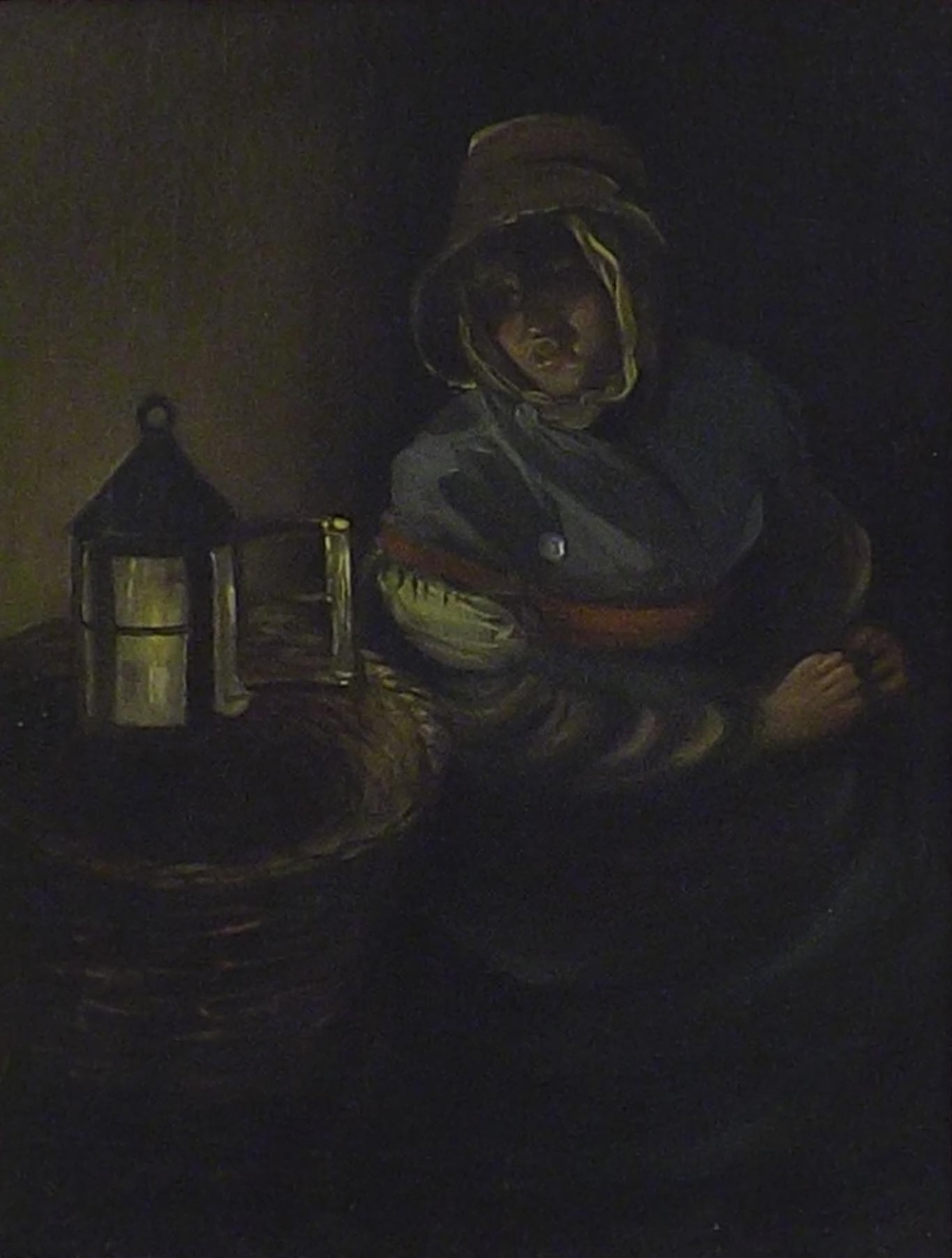 19th Century Dutch School - Interior study of a seated lady in a bonnet beside a lantern, oil on