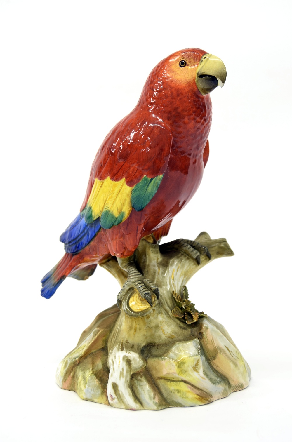 Meissen porcelain model of a parrot, modelled perched upon a naturalistic base, in shades of red,