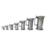 Matched set of seven graduated French straight-sided pewter lidded measures, circa 1880,