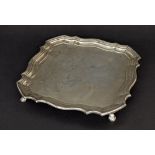 George V silver square salver with a piecrust moulded border on four hoof feet, London 1919, 8.