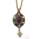 Rare 19th century Holbeinesque gold and enamel oval pendant, the central cabouchon garnet set within