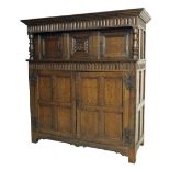 Good 18th century large carved oak court cupboard, the carved cornice over a central carved
