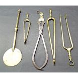 Antique metalware to include three pairs of brass ember tongs; brass salamander and an adjustable