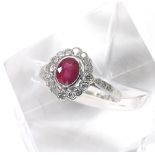 18ct white gold oval ruby and diamond cluster ring, the ruby 1.13ct approx, in a surround of round