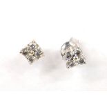 Pair of white metal four stone diamond studs, 5mm (at fault, one back missing, the other marked 925)