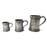 Set of three graduated straight-sided pewter measures, circa 1850, with reinforced rims inscribed '