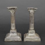 Pair of Edward VII silver repousse candlesticks, with detachable sconces over Corinthian pillars