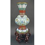 Large Chinese cloisonne vase on stand, with butterfly and scroll design, upon ornate hardwood