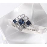 18ct white gold sapphire and diamond dress ring in the Art Deco manner, with a row of three