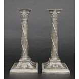 Pair of late Victorian silver repousse candlesticks, with detachable sconces and cast capitals, leaf