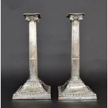 Pair of George III silver candlesticks, with detachable sconces over Corinthian columns upon