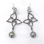 Pair of attractive white gold open work design drop earrings, set with white and black treated round