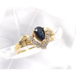 18ct sapphire and diamond ring, the pear shaped sapphire over seven small round brilliant-cut