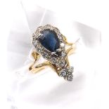 Yellow gold sapphire and diamond pear shaped cluster ring, the sapphire within a surround of round