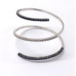 18k white gold blue sapphire and diamond open coiled bangle, with a central channel of thirty