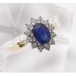 Sapphire and diamond 9ct oval cluster ring, the blue sapphire in a surround of round brilliant-cut