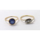 18ct three stone crossover design ring, ring size O; together with a single blue synthetic