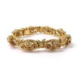 Ornate 18ct yellow gold ruby and diamond set bracelet, with eight raised links each with articulated