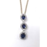 Attractive modern 18ct white gold sapphire and diamond triple cluster pendant, the sapphires