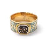 Attractive Victorian gold and enamel child's bangle, with a foliate plaque and blue key design
