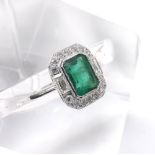 18ct white gold emerald and diamond cluster ring, the emerald estimated 1.1ct approx, in a