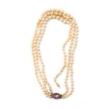Cultured pearl three strand necklet with an oval andalusite and rose diamond set clasp, pearls