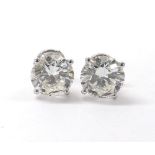 Fine impressive large pair of round brilliant-cut diamond ear studs, in 18k white gold four claw