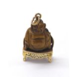 Tiger's eye 9ct Buddha charm, circa 1961, 7.7gm, 31mm