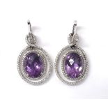 Pair of 18ct white gold amethyst and diamond oval earrings, the oval amethysts in a drop setting