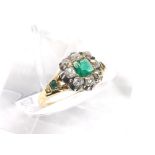 Attractive emerald and diamond cluster ring, the central emerald in a surround of eight old-cut