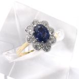18ct sapphire and diamond oval cluster ring, the sapphire 0.8ct approx, in a surround of eight round