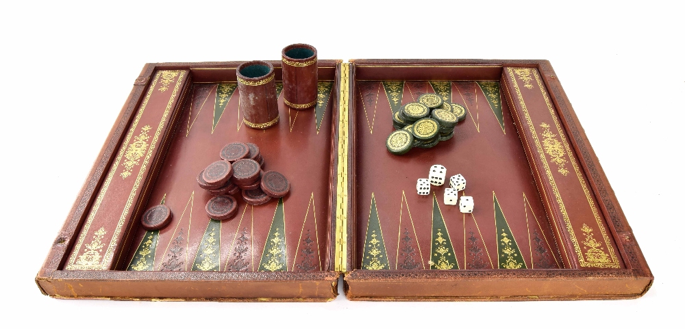 Large attractive tooled leather backgammon box, with original shakers and counters