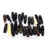 Twenty-five assorted saxophone mouthpieces including Selmer, Yamaha and Dearman etc