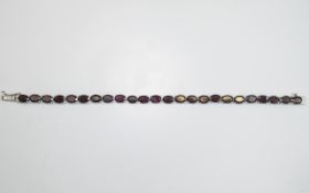 Indian Garnet Tennis Bracelet, 26cts of the rich red and blackcurrant toned garnet set in platinum