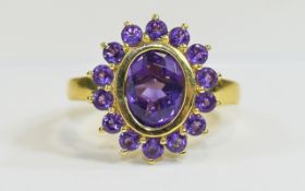 Amethyst Cluster Ring, an oval cut purple amethyst of 2.5cts, bezel set and framed with fourteen